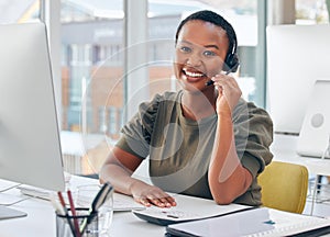 Im always happy to help. Shot of a woman wearing a headset while working in a call centre.