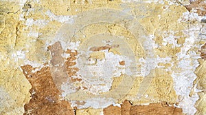 A shot of a Worn, old wall with cracked paint and plaster