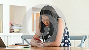 Shot of a young female using mobil phone.