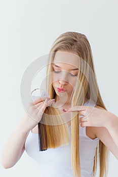 Shot of young girl chooses hair color from a tester of hair strands in a beauty salon.