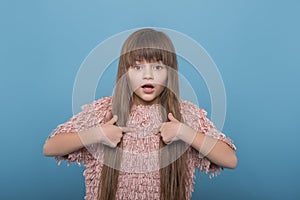 Shot of  young girl  emotionally proving something against  blue background with copy space