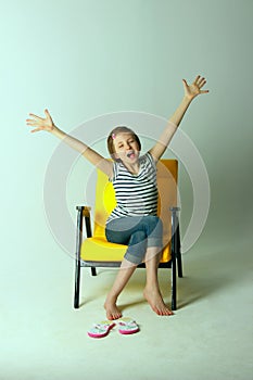 Shot of a young girl stretching her arms and yawning. photo