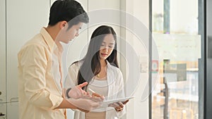 Shot of Young men and women use tablets to find and plan their wedding