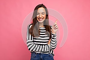 Shot of young positive smiling happy attractive brunette woman with sincere emotions wearing casual striped longsleeve