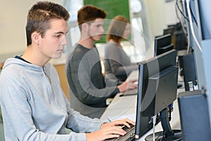 Shot young students sitting in computer room