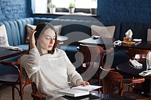 Shot of a young stylish woman using a digital tablet in a cafe Coffee and a great book. Life`s good