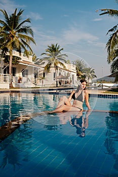 Shot of a young woman relaxing by the luxury pool. Summer vacation