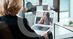 A lifeline for life under lockdown. Shot of a young woman having a counselling session with a psychologist using a video photo