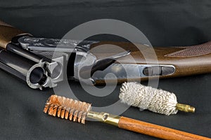 Shotgun and Gun Cleaning Items on a Baize Table