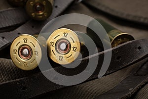 Shotgun shells close-up. Ammunition for smoothbore weapons on a khaki canvas backpack. Dark back