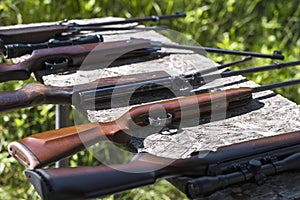 Shotguns on a table outdoor