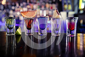 Shots with liquor and alcohol in cocktail bar photo