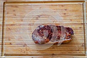 Shots of a sliced fresh rump steak with fat on  the steak on a wooden board
