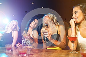 We should do this more often. young women drinking cocktails in a nightclub.
