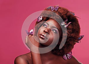 Should I make this my signature look. Studio shot of a beautiful young woman posing topless with butterflies in her hair