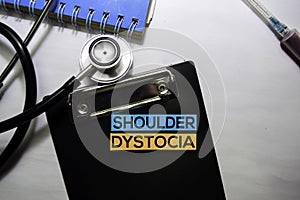 Shoulder Dystocia text on top view isolated on white background. Healthcare/Medical concept