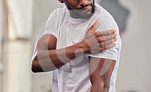 Shoulder pain, fitness and black man with injury in gym after accident, workout or training. Sports, health and male