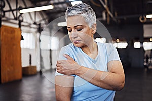 Shoulder pain, fitness and senior woman at gym in training, workout or lose weight exercise with health risk. Injury