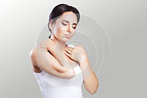 Shoulder pain. The woman holds two hands over the neck and shoulders. Dislocation. Cold. Muscle tension The concept of health. On