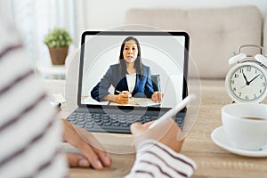 Shoulder view. hand of Asian women Video Conference online with leadership On the tablet, Businesswoman work from home