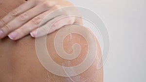 Shoulder and woman back body lotion spreading slow motion close-up