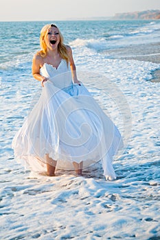 Shouting bride in sea spume