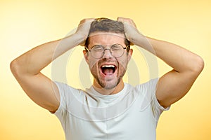 Shouting frustrated guy tearing his hair