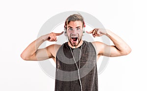 Shouting guy listening to music in stereo headset. mp3 player. sexy muscular man listen music on phone mp3 player. man