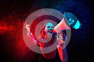 Shouting with megaphone. Young woman with smoke and neon light on black background. Highly tensioned, wide angle, fish