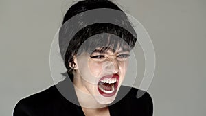 Shouting mouth, screaming face. Angry woman screaming with rage, furious and dangerous. Girl shouting with anger. Rage