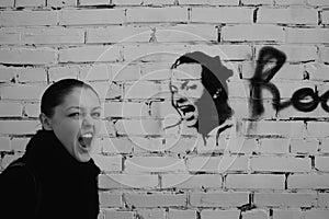 Shouting woman on a brick wall