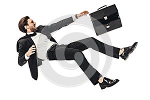 shouting young businessman falling with briefcase