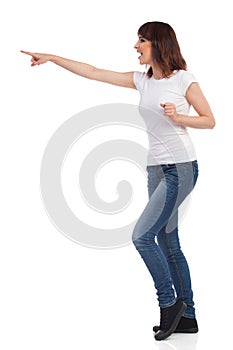 Shouting Young Woman Is Pointing. Side View Isolated