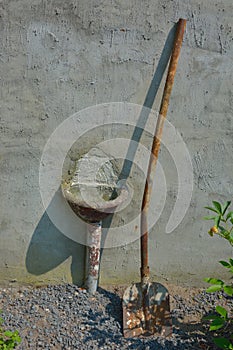 Shovel and decayed old sink