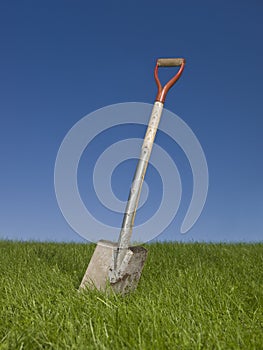 Shovel in green grass
