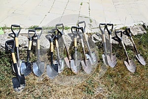 shovel for planting, Seasonal works in the garden . Shovels for digging the ground on a pile of soil . Many shovels