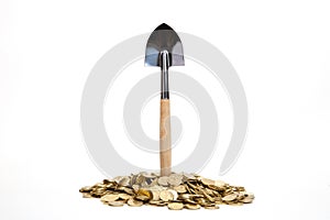 Shovel standing in pile of coins