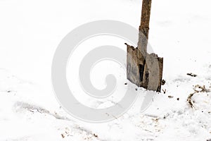 Shovel sticking in the snow on a cold day