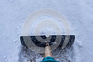 Shoveling snow in a winter driveway