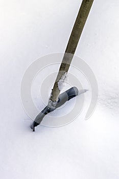 Shoveling snow in winter, Metal shovel in the snow