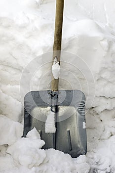Shoveling snow in winter, Metal shovel in the snow