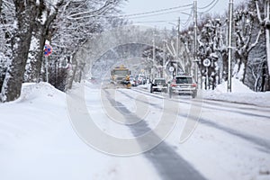 Shovelling snow from the road and blowing snow, snowy roads on a winter day, close-up