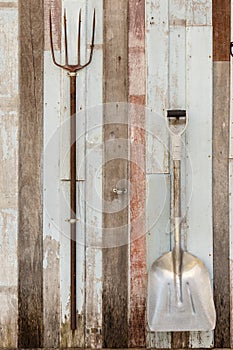 Shovels on vintage wooden wall