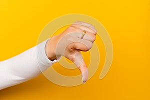 dislike thumbs up on a yellow paper background disapproving and disapproving gestures disagreeing with what you don't like photo