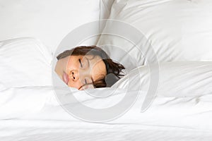 Only show face woman in white blanket tucked sleep on the bed