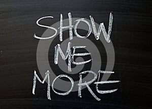 Show Me More written on a Blackboard