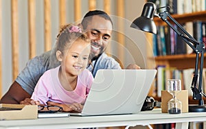 Show me what youd do. Shot of a young father showing his daughter his work.