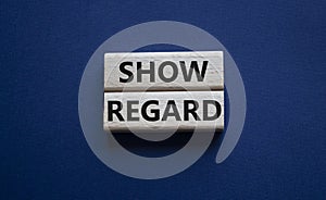 Show regard symbol. Wooden blocks with words Show regard. Beautiful deep blue background. Business and Show regard concept. Copy