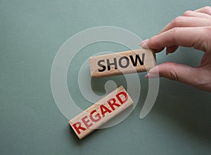 Show regard symbol. Wooden blocks with words Show regard. Beautiful grey green background. Businessman hand. Business and Show