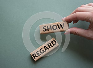 Show regard symbol. Wooden blocks with words Show regard. Beautiful grey green background. Businessman hand. Business and Show